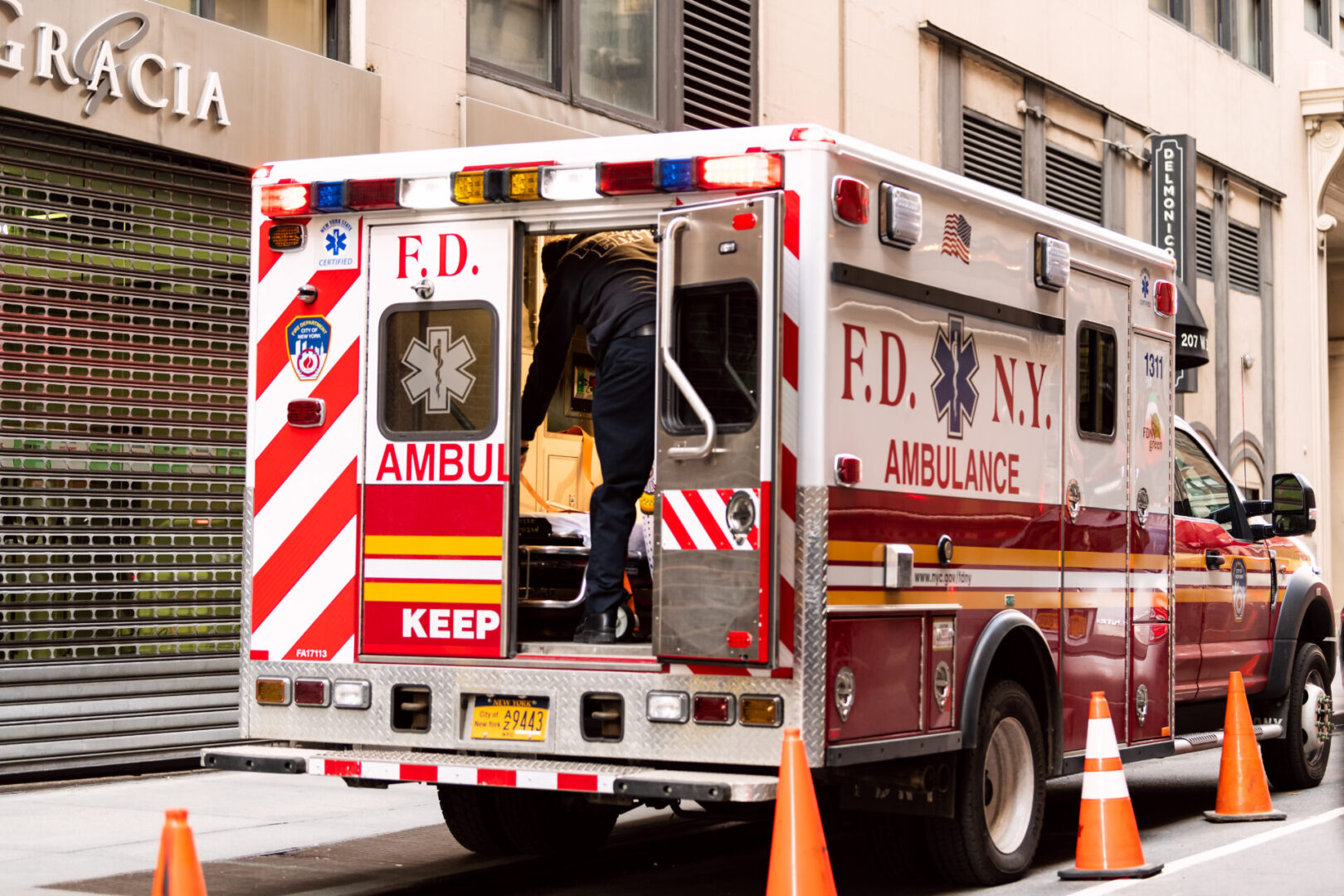 New York City - April 6, 2018: NYC midtown with FDNY red ambulance open truck parked on street